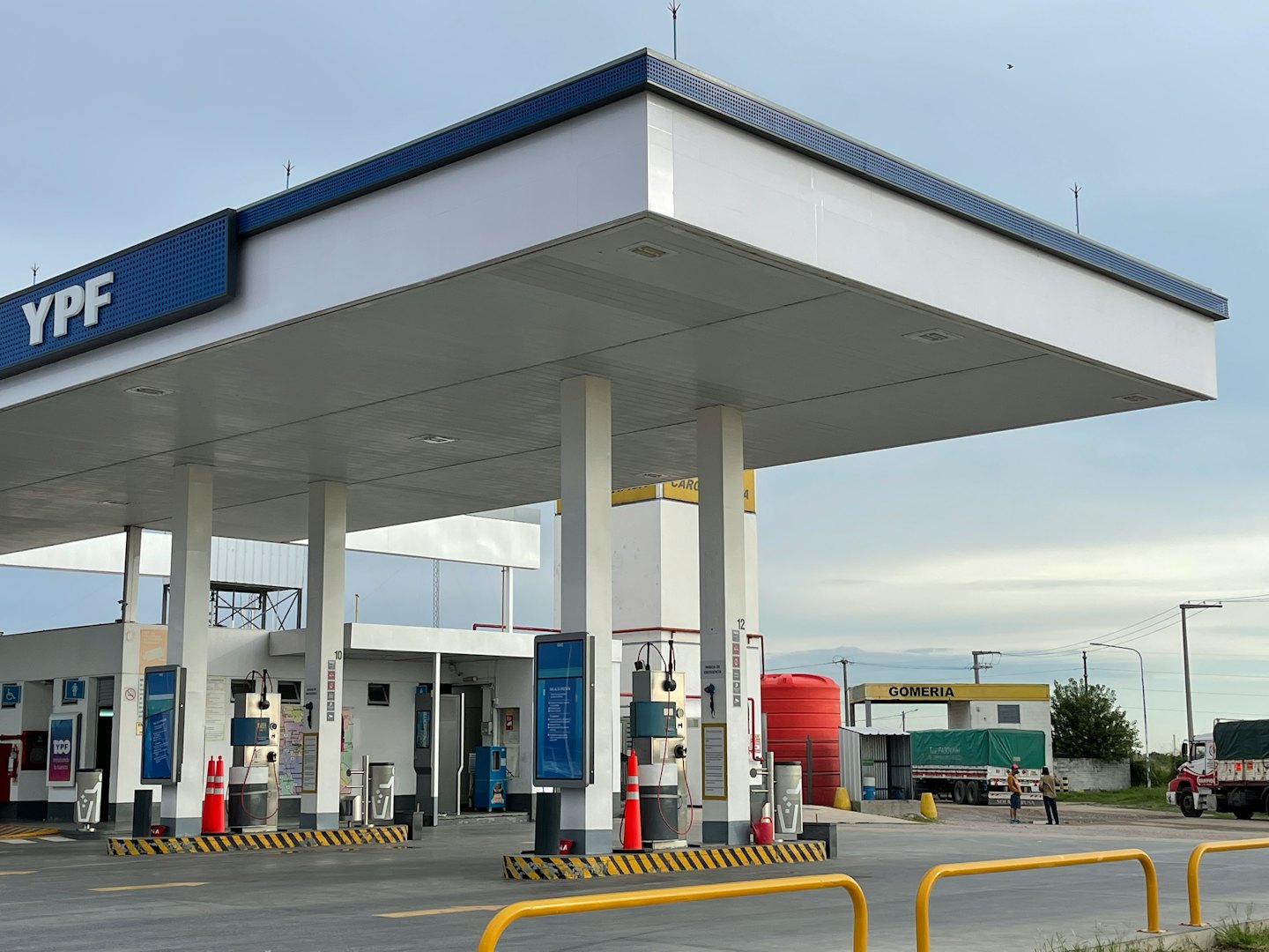 Modern gas station canopy covering multiple fuel pumps.